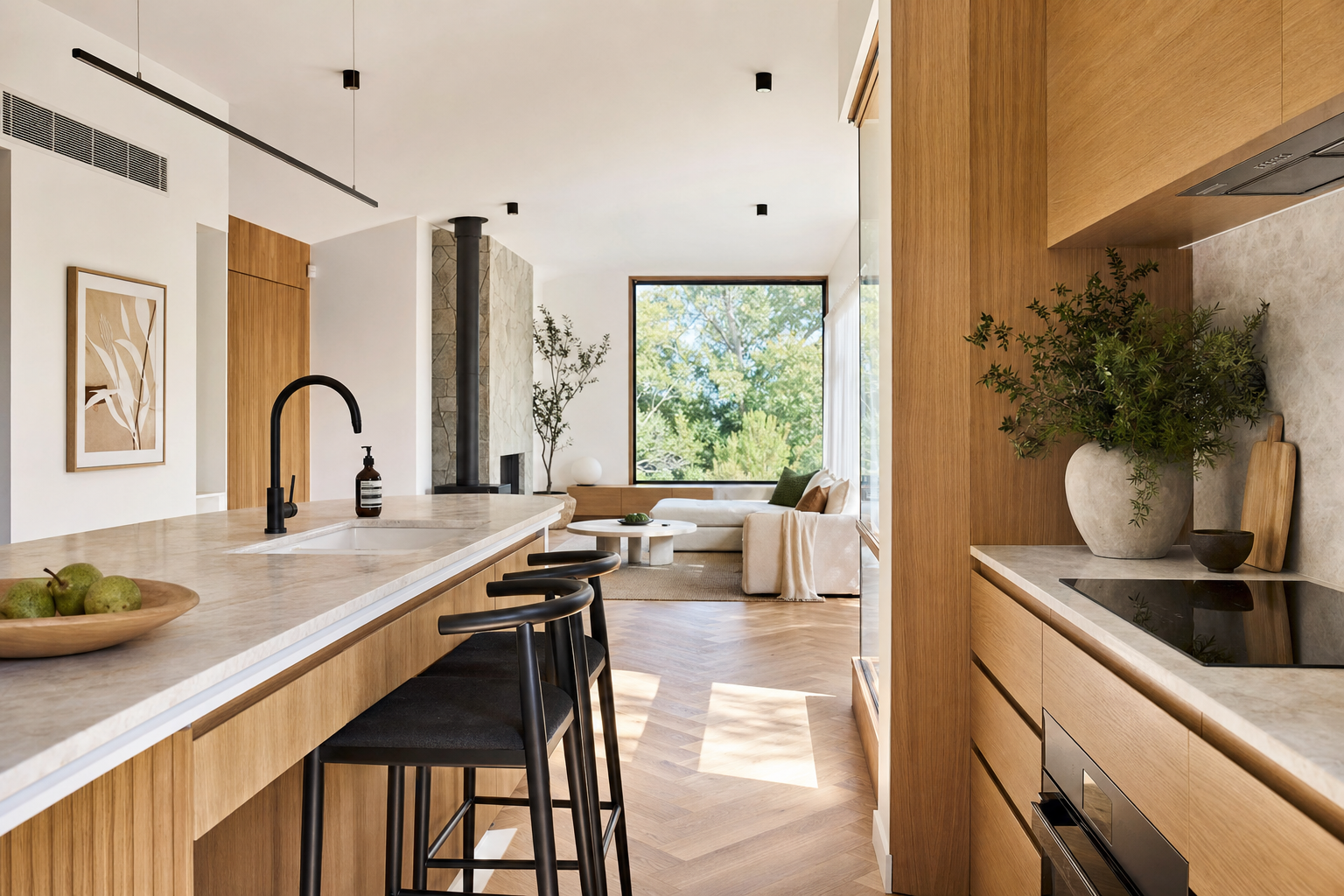 Freshly renovated modern kitchen with herringbone timber floors and stone benchtop